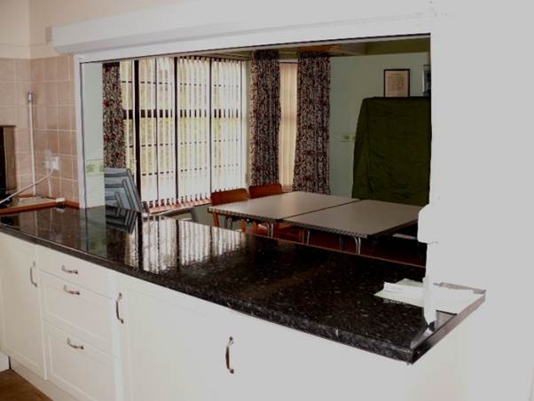 A kitchen with a black counter top

AI-generated content may be incorrect.